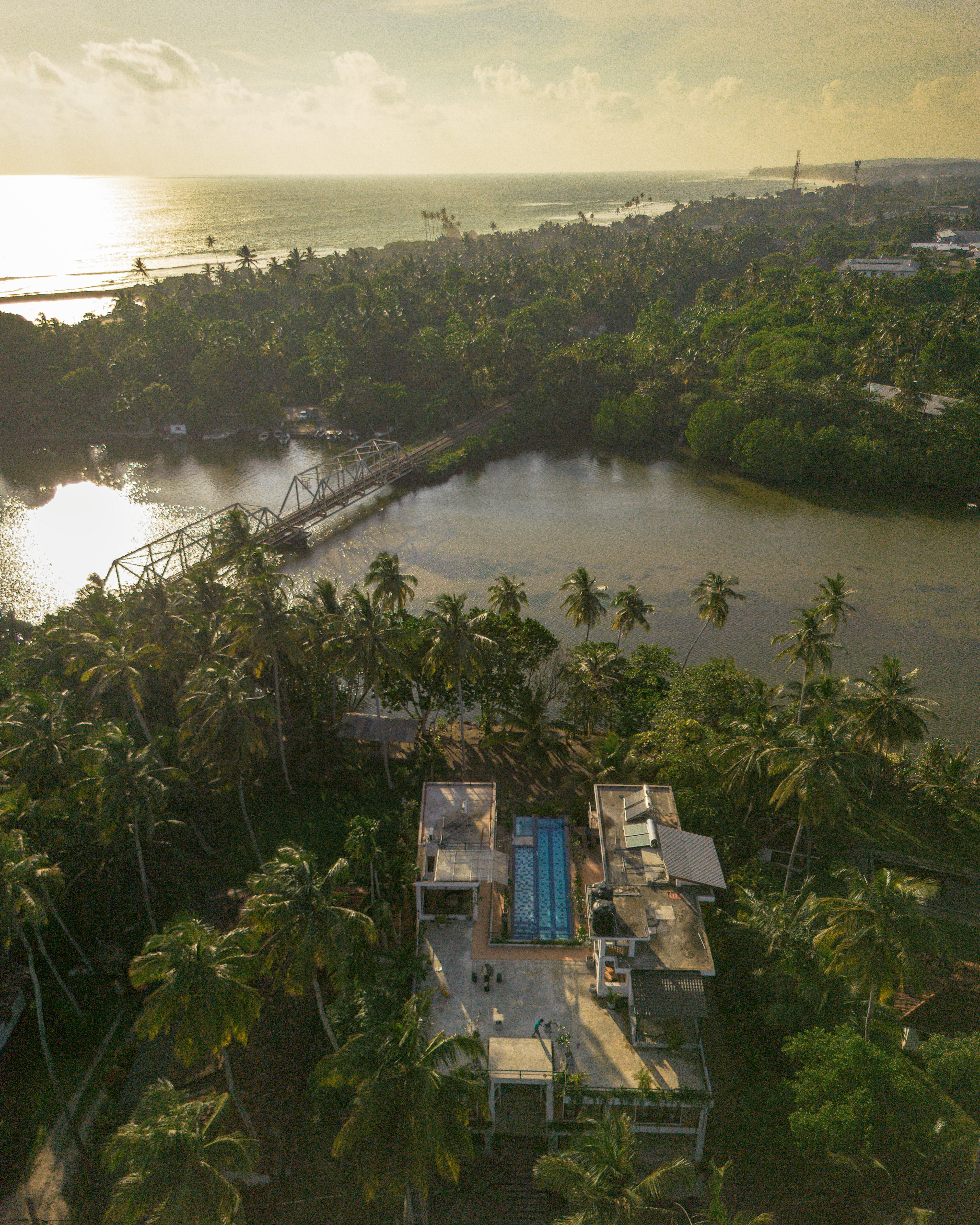 Aerial view of Ko Lake Villa looking out toward the Koggala Lake sunset horizon