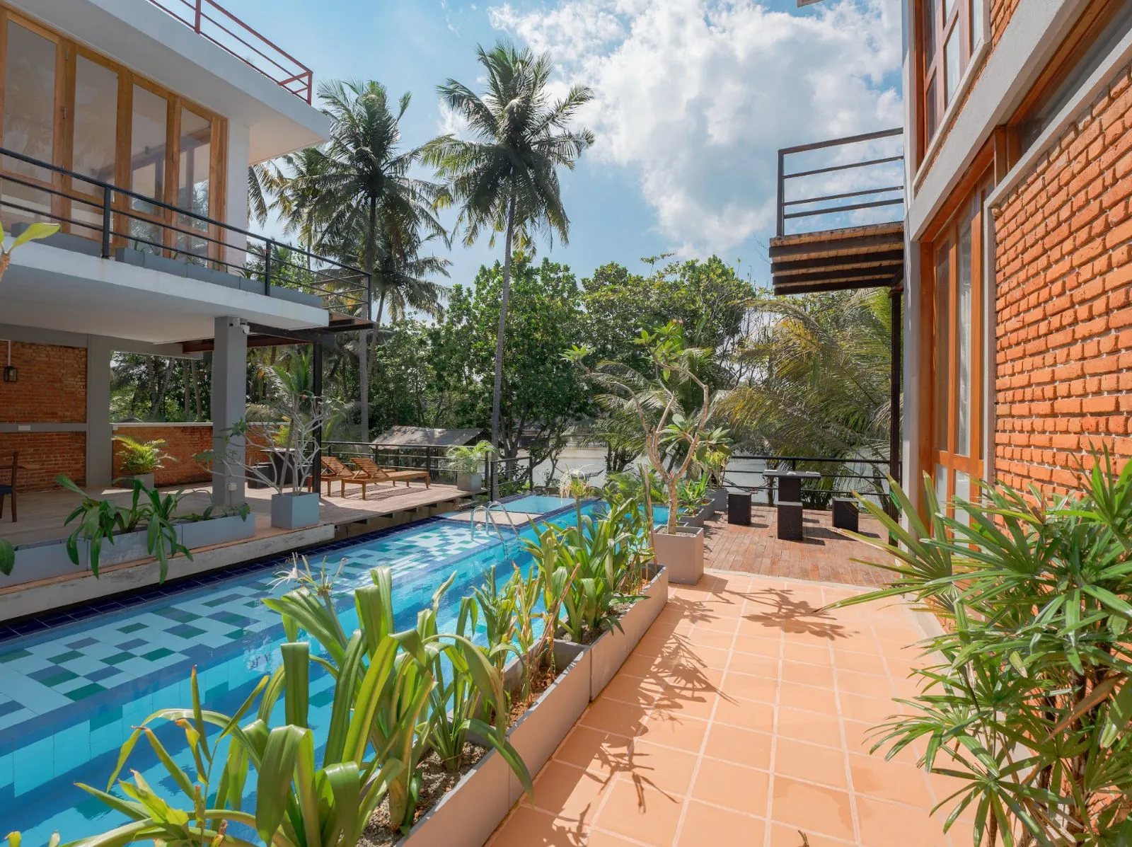 Ko Lake Villa team serving guests on the pool deck